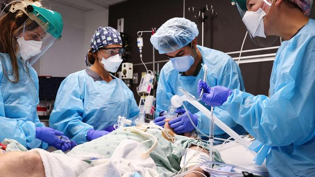 Clinicians work on intubating a COVID-19 patient in the Intensive Care Unit picture Mario Tama/Getty Images/AFP