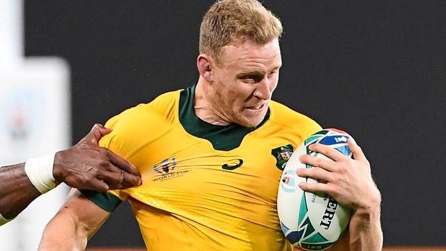 Australia's wing Reece Hodge is tackled during the Japan 2019 Rugby World Cup Pool D match between Australia and Fiji at the Sapporo Dome in Sapporo on September 21, 2019. (Photo by WILLIAM WEST / AFP)