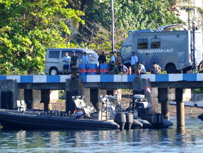 Indonesian navy personnel are seeing resting as search operations for the missing vessel turn to retrieval. Picture: AFP