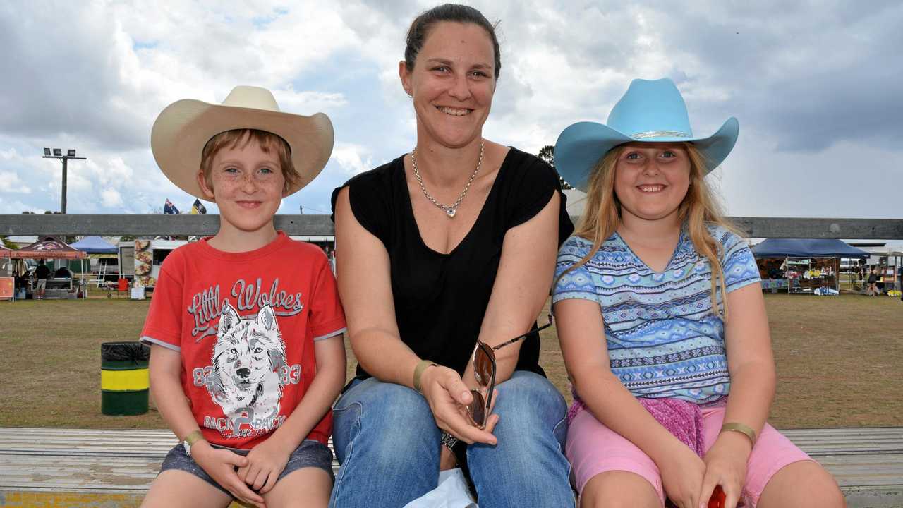 HATS ON: Chelsea, Lachlan and Michelle Howard watch the rope and tie category at the Lowood rodeo. Picture: Meg Bolton