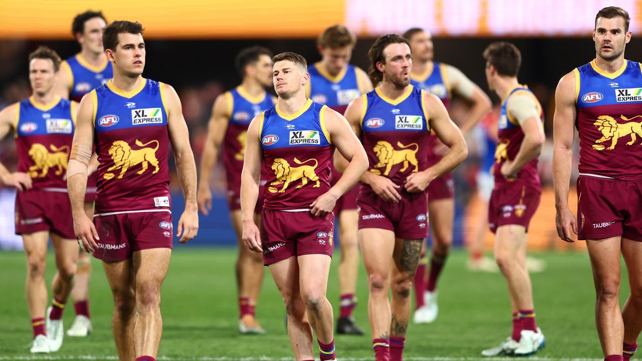 Lions players leave the field after losing to the Demons. Picture: Chris Hyde