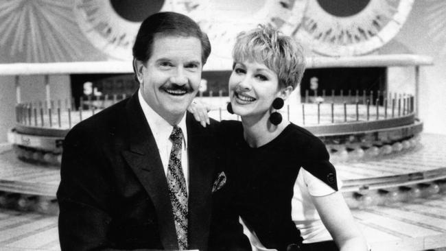 Wheel of Fortune hosts John Burgess and Adriana Xenides on the Wheel of Fortune set in 1991.