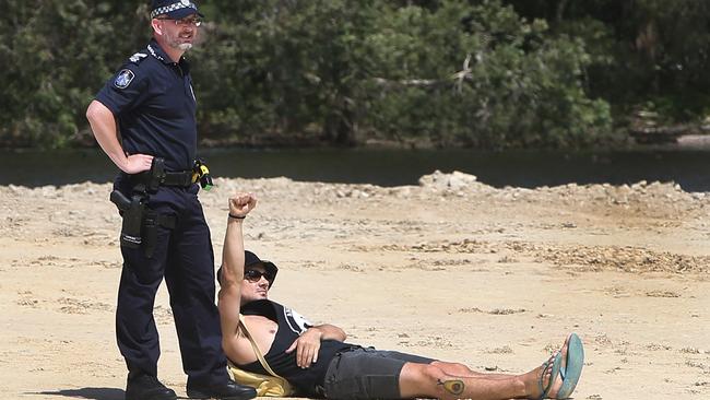 Black Swan Lake protest at Bundall goes to another level, with protesters chaining themselves to the fence and then getting themselves arrested after running onto the worksite and stopping the trucks. Protester known only as 
