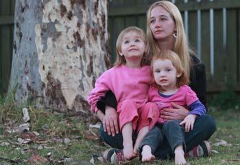 TORN APART: Michele Wood with daughters Rose, 4, and Angel, 2. Picture: Jono Searle.