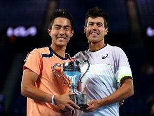 MELBOURNE, AUSTRALIA - JANUARY 29: Rinky Hijikata and Jason Kubler of Australia pose with the championship trophy in the Men’s Doubles Final against Hugo Nys of France and Jan Zielinski of Poland during day 13 of the 2023 Australian Open at Melbourne Park on January 29, 2023 in Melbourne, Australia. (Photo by Graham Denholm/Getty Images)