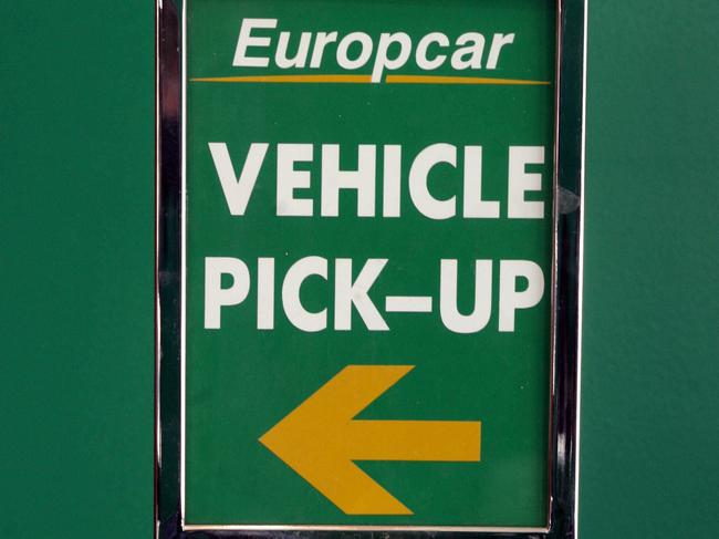 Europcar pick-up & vehicle return signs at local franchise of car rental film, in Melbourne.