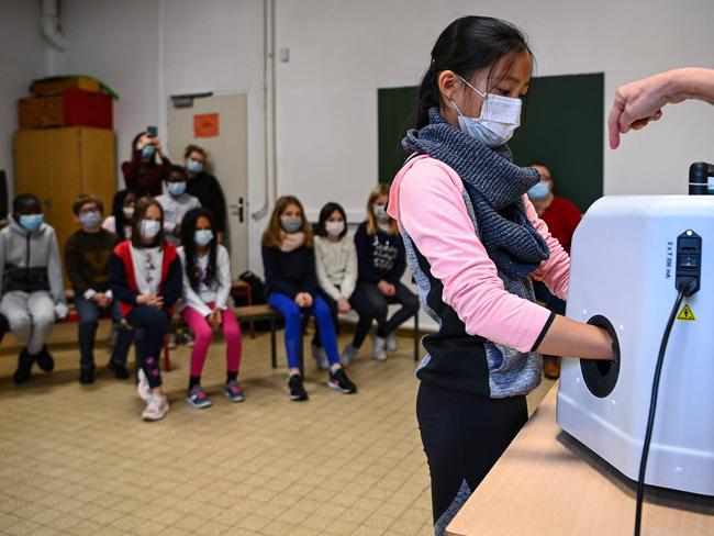 French pupils are shown how to use an automatic hand washing unit. Picture: AFP.