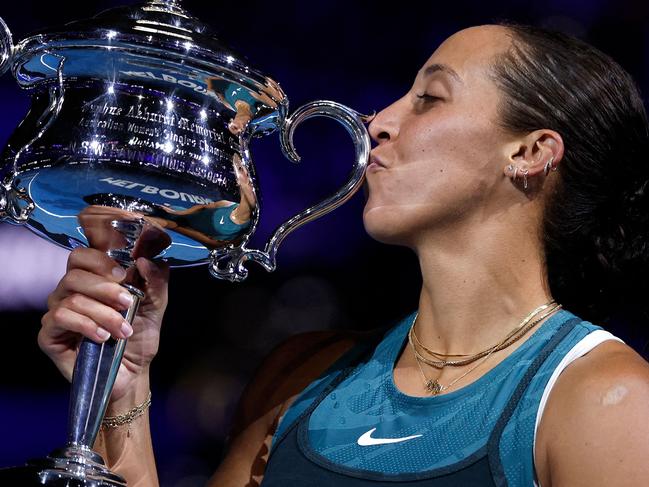 USA's Madison Keys celebrates with the Daphne Akhurst Memorial Cup after defeating Belarus' Aryna Sabalenka during their women's singles final match on day fourteen of the Australian Open tennis tournament in Melbourne on January 25, 2025. (Photo by Martin KEEP / AFP) / -- IMAGE RESTRICTED TO EDITORIAL USE - STRICTLY NO COMMERCIAL USE --