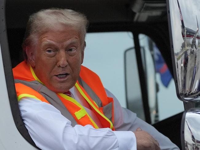 Republican presidential nominee former President Donald Trump talks to reporters as he sits in a garbage truck Wednesday, Oct. 30, 2024, in Green Bay, Wis. (AP Photo/Julia Demaree Nikhinson)