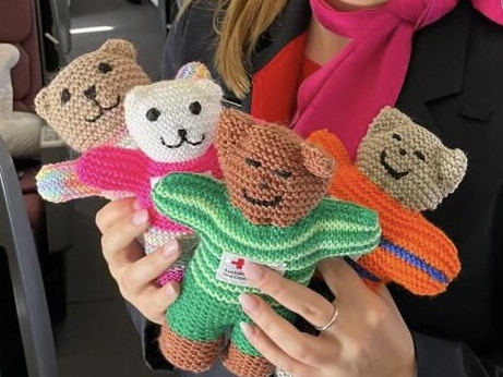 Teddies from Red Cross handed out to children on the Qantas repatriation flight, bringing Australians home from Israel. Picture: Qantas