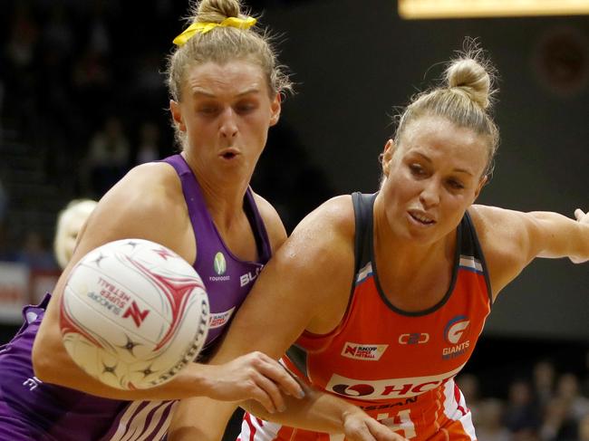 Gabi Simpson of the Firebirds (left) and Kimberlee Green of the Giants fight for the ball during the Round 4 Super Netball match between the Giants Netball and the Queensland Firebirds at Quaycentre in Sydney, Saturday, May 19, 2018. (AAP Image/Daniel Munoz) NO ARCHIVING, EDITORIAL USE ONLY