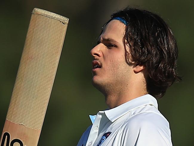 SYDNEY, AUSTRALIA - OCTOBER 10: Sam Konstas of the Blues raises his bat in the air after hitting a six to reach his century during the Sheffield Shield match between New South Wales and South Australia at Cricket Central, on October 10, 2024, in Sydney, Australia. (Photo by Mark Evans/Getty Images)