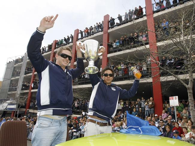 Joel Selwood and Mathew Stokes are watched by hundreds of locals in a premiership parade in 2007. Picture: Andrew Brownbill