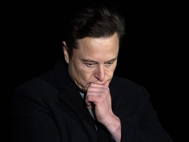 (FILES) In this file photo taken on February 10, 2022 Elon Musk pauses and looks down as he speaks during a press conference at SpaceX's Starbase facility near Boca Chica Village in South Texas. - A Twitter account that tracked flights of Elon Musk's private jet was grounded on December 14, 2022 despite the billionaire's talk of free speech. (Photo by JIM WATSON / AFP)