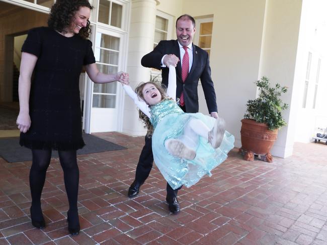 Treasurer Josh Frydenberg with his wife Amie swing their daughter Gemma after the swearing in ceremony. Picture: Gary Ramage