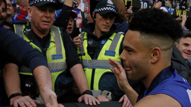 Even the boys in blue wanted to get up close with Jason Johannisen. Picture: Wayne Ludbey