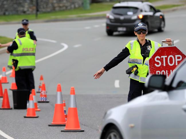 Coomera Police which are part of the Northern Patrols Group,  direct traffic to stop and pull over for a Random Breath Test on Rose Valley Drive Upper Coomera.                              Photo Scott Powick Newscorp