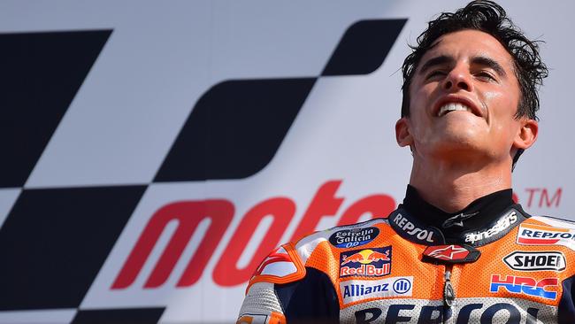 Spanish rider Marc Marquez listens to his country’s national anthem on the podium.