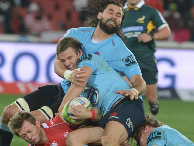 JOHANNESBURG, SOUTH AFRICA - MAY 30: Rob Horne of the Waratahs tackles Ruan Combrinck of the Lions during the Super Rugby match between Emirates Lions and Waratahs at Emirates Airline Park on May 30, 2015 in Johannesburg, South Africa. (Photo by Lee Warren/Gallo Images/Getty Images)