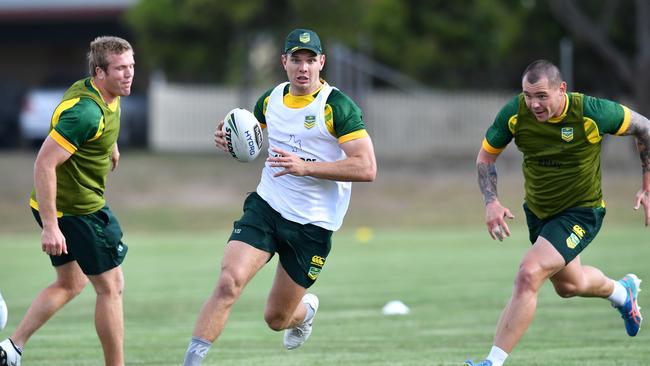 Tom Trbojevic (centre) gets past Jake Trbojevic (left) and David Klemmer (right) during a Kangaroos training session in Brisbane. Picture: AAP