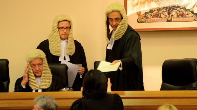 Chief Justice Chris Kourakis and Justice Sam Doyle, pictured standing, and Justice Malcolm Blue said any broader publication could prompt “unfiltered and uncontrolled” public speculation.