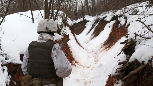 An Ukrainian serviceman walks along a snow covered trench on the frontline with the Russia-backed separatists near Avdiivka, Donetsk region, on February 2. Picture: AFP