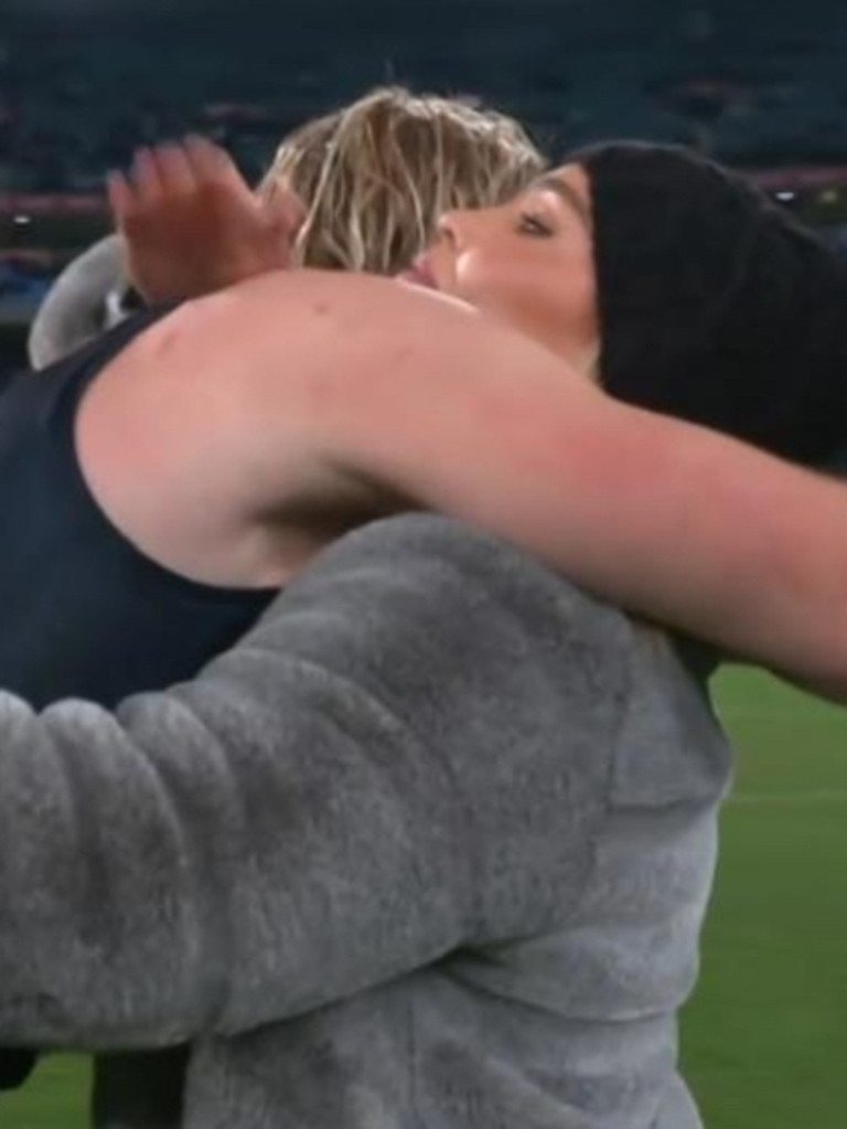 Abbey Holmes is hugged by Carlton's Tom De Koning on Friday night