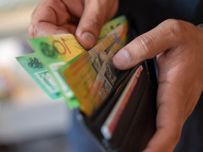 a male taking money out of the valet.