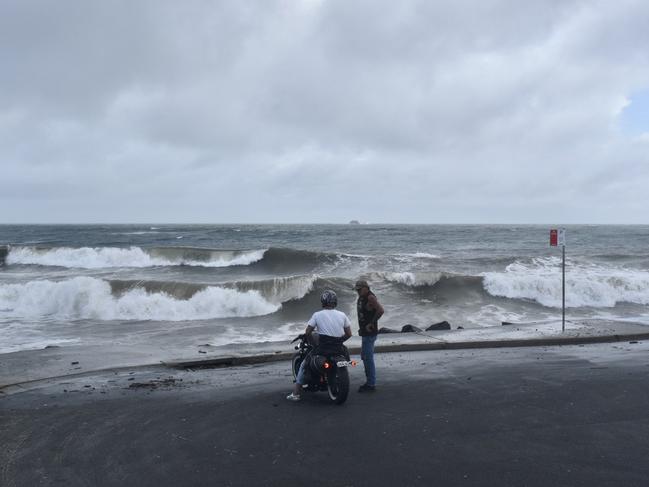 Main beach in Byron Bay remained closed but many visitors and residents decided to go and check out the high tide on Tuesday morning.