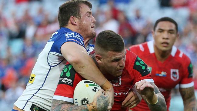 Josh Dugan of the Dragons is tackled by Josh Morris of the Bulldogs.