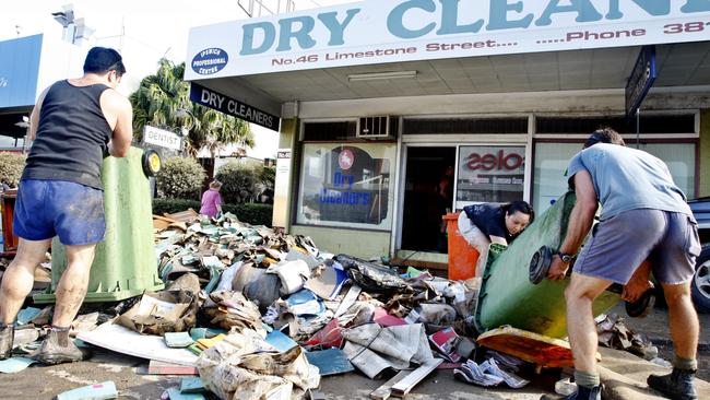 The clean up begins on Limestone Street, Ipswich on Thursday after flood water subsided. Picture: Sarah Harvey