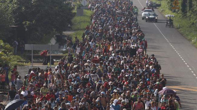 Central American migrants walking to the U.S. start their day departing Ciudad Hidalgo, Mexico, on Sunday, Oct. 21, 2018. Despite Mexican efforts to stop them at the border, a growing throng of Central American migrants resumed their advance toward the U.S. border early Sunday in southern Mexico. (AP Photo/Moises Castillo)