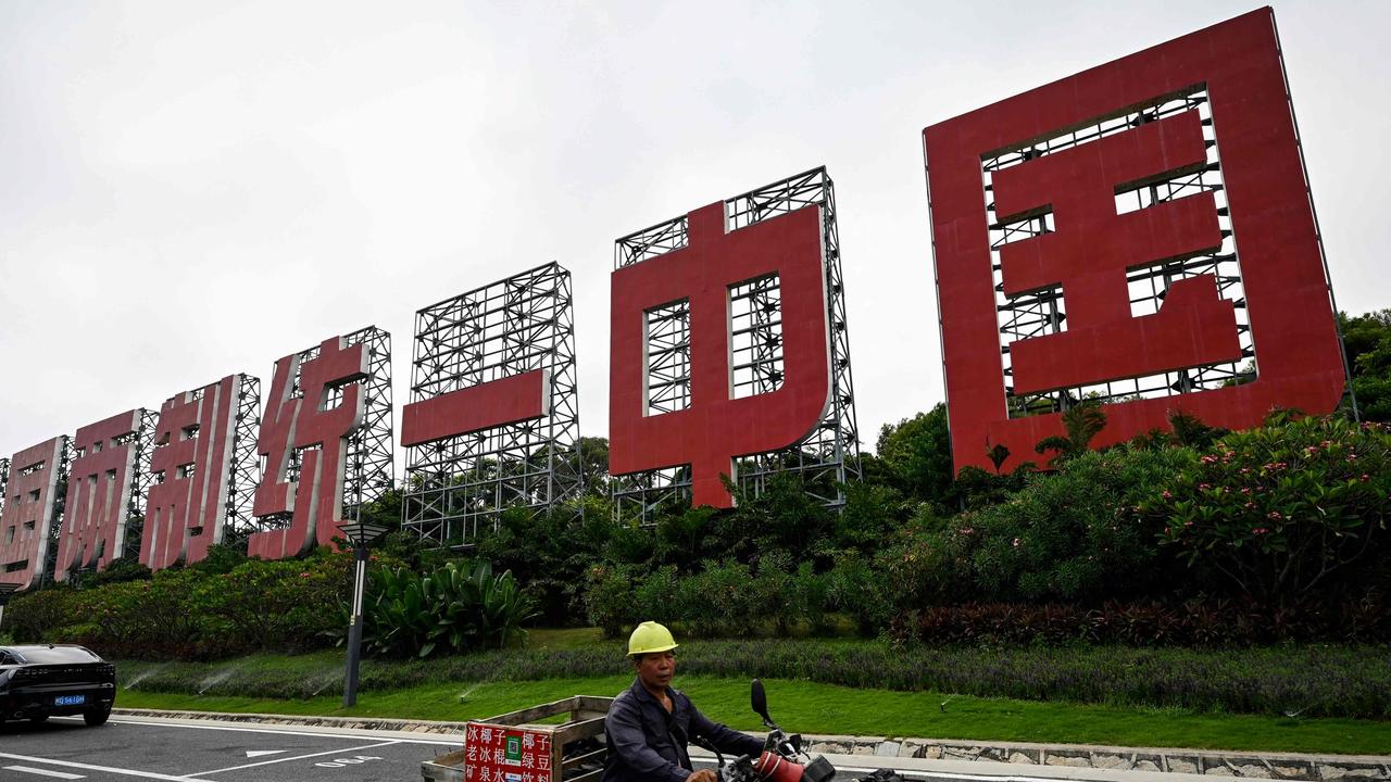 A giant sign proclaiming "One Country, Two Systems, Unify China" in Xiamen, in China's southern Fujian province. (Photo by Jade GAO / AFP)