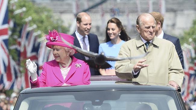 Queen Elizabeth II and Prince Philip, Duke of Edinburgh, followed by Prince William, Duke of Cambridge, Catherine, Duchess of Cambridge and Prince Harry, at the Queen's 90th birthday on The Mall on June 12, 2016.