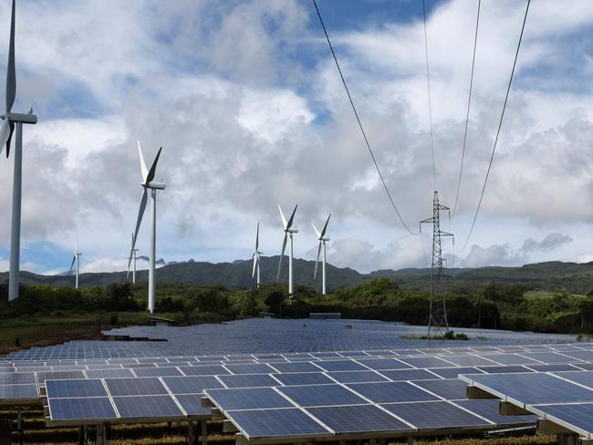 TOPSHOT - This photograph shows TotalEnergies' solar panels and wind turbines at the La Perriere wind farm in Sainte-Suzanne on the French overseas island of la Reunion, on January 22, 2025. (Photo by Richard BOUHET / AFP)