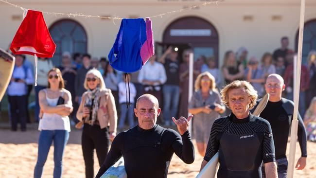 Nick Carrolly (left) taking part in the paddle-out. Picture: (AAP Image / Julian Andrews).