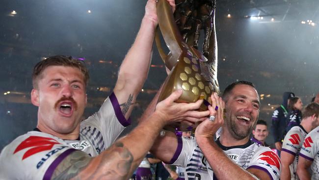 SYDNEY, AUSTRALIA - OCTOBER 25: Cameron Munster of the Storm and Cameron Smith of the Storm pose with the Premiership trophy after winning the 2020 NRL Grand Final match between the Penrith Panthers and the Melbourne Storm at ANZ Stadium on October 25, 2020 in Sydney, Australia. (Photo by Cameron Spencer/Getty Images)