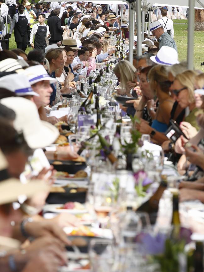 Diners at a half-kilometre-long table for the 2021 World's Longest Lunch in Melbourne, part of the Melbourne Food and Wine Festival. Covid-19 forced the cancellation of the festival’s winter program this year. Picture: NCA NewsWire / Daniel Pockett