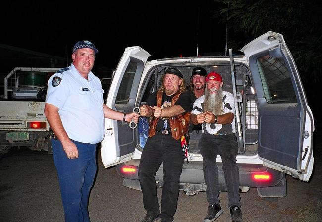 ON THE JOB: Andrew Gale "arresting” country rock group The Wolverines at the Dirt and Dust festival during his time as a cop at Julia Creek. Picture: Contributed