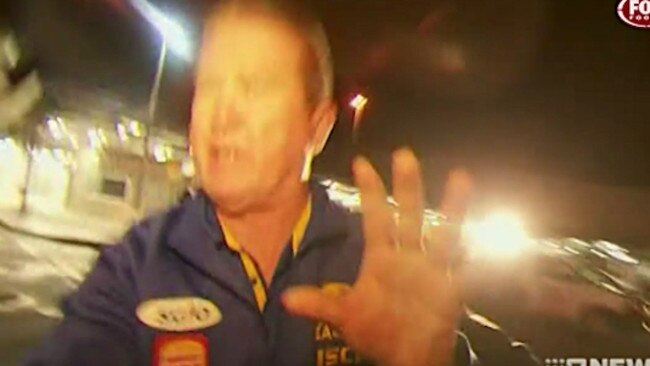 West Coast Eagles official Peter Staples then turned on a cameraman who was filming the arrival of player Nic Naitanui on crutches from a distance.