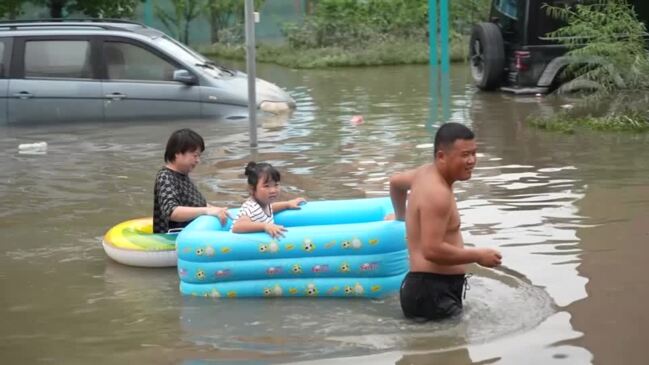 Rescuers use construction loaders in flood-hit China | news.com.au ...