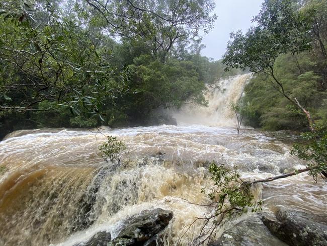 Somersby Falls during yesterday's severe weather. Picture: Daniel Rond