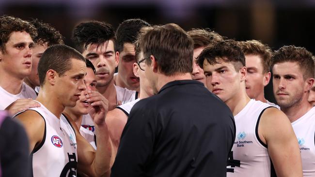 Carlton players listen to Teague at three-quarter time against Port Adelaide in Adelaide.