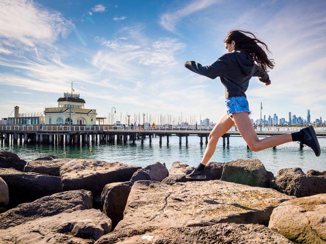 Eva, 13, jumps on rocks near St Kilda Pier, which is to be redeveloped. Picture: Jake Nowakowski