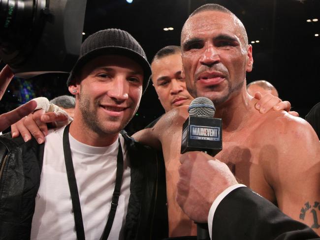 Hughes (left) with Anthony Mundine in the ring post-fight in 2009. Picture: AAP Image/Paul Harris