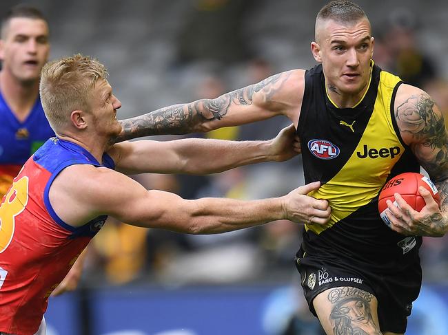 Dustin Martin of the Tigers (right) and Nick Robertson of the Lions contest during the Round 17 AFL match between the Richmond Tigers and the Brisbane Lions at Etihad Stadium in Melbourne, Sunday, July 16, 2017. (AAP Image/Julian Smith) NO ARCHIVING, EDITORIAL USE ONLY