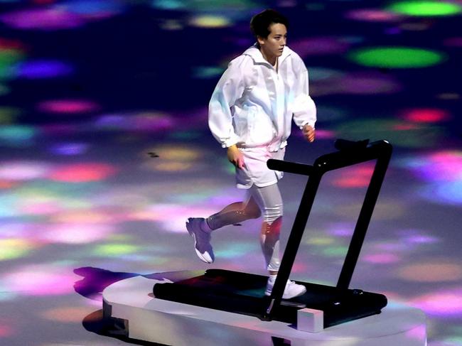 TOKYO, JAPAN - JULY 23: A performer runs on a treadmill during the Opening Ceremony of the Tokyo 2020 Olympic Games at Olympic Stadium on July 23, 2021 in Tokyo, Japan. (Photo by Clive Brunskill/Getty Images)