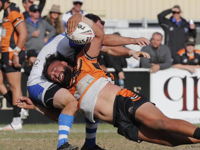 Piki Te Ora Rogers of Southport Tigers is challenged by Samuel Meskell of Tugun Seahawks. Photo: Regi Varghese