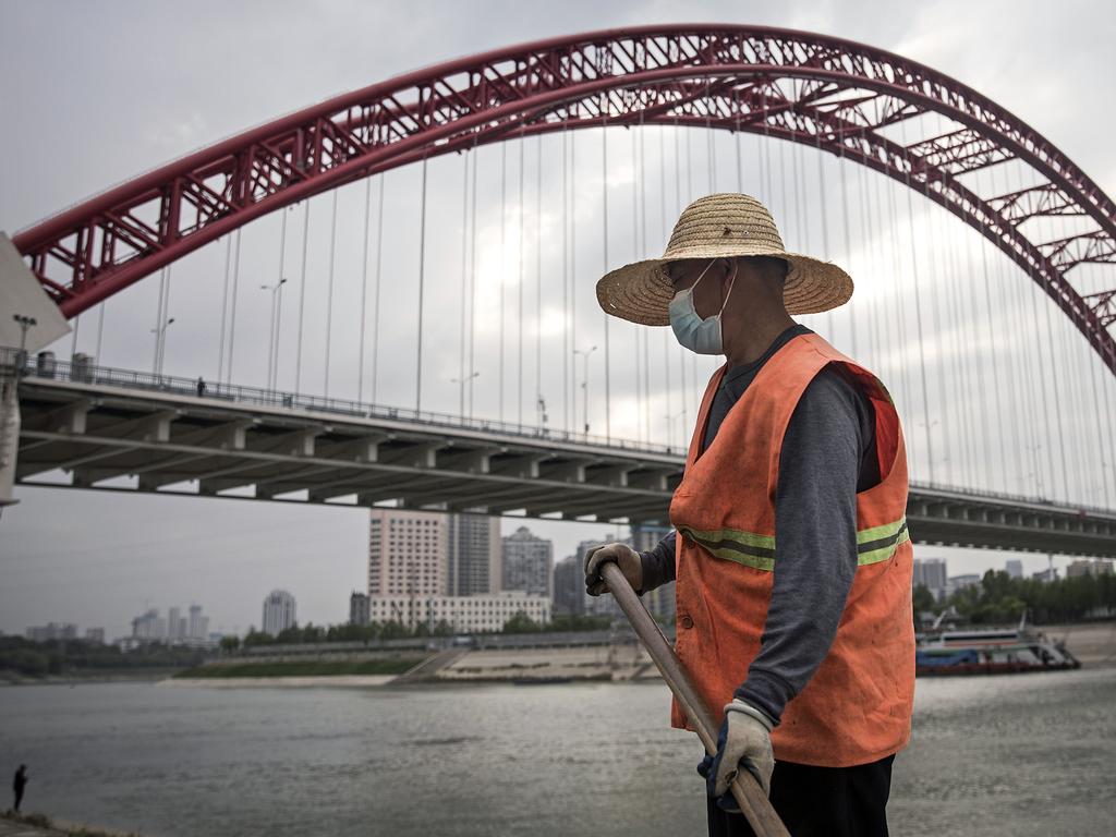 A cleaner works under Han river bridge in Wuhan. Picture: Getty