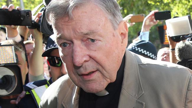 TOPSHOT - Cardinal George Pell (C) makes his way to the court in Melbourne on February 27, 2019. - Cardinal George Pell arrived in court, possibly for the last time as a free man, in a last-ditch push to apply for bail after his historic conviction for child sex crimes. (Photo by Con CHRONIS / AFP)